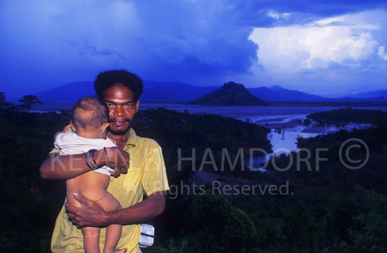 Forced from his traditional home on the western flanks of Mt. Pinatubo, an Aeta tribeman and his child stand before the lahar choked San Tomas River, Zambales.