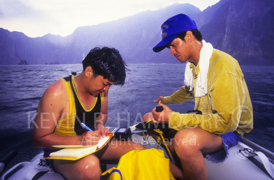 Philvolcs (Philippine Institute of Volcanology and Seismology) geologist monitor Mount Pinatubo Crater Lake water (In 1994 - pH 3, temperature 40 degree C).The rain so cold that we rowed over to the protruding magma dome island (in background) to warm ourselves from it’s radianting heat!